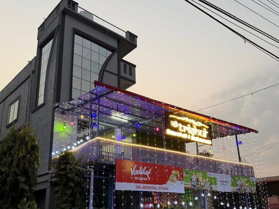 Front of the building with the covered rooftop restaurant and fairy lights
