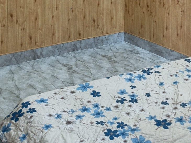 Wood-panelled room with marble-effect flooring