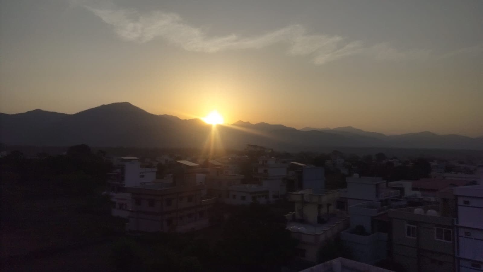 Sun setting behind the hills, seen from the rooftop